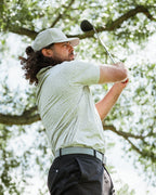 Men’s Drinking Buddies golf polo by Pins & Aces featuring a subtle drinking-inspired all-over print on a cream short-sleeve performance polo with an athletic fit.