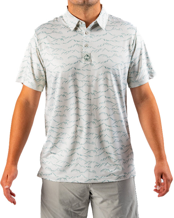 Men’s Altitude Adjustment golf polo by Pins & Aces featuring an off-white base with a subtle blue-green mountain range print, short sleeves, and athletic performance fit.