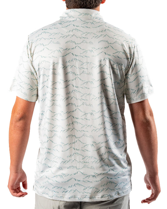 Men’s Altitude Adjustment golf polo by Pins & Aces featuring an off-white base with a subtle blue-green mountain range print, short sleeves, and athletic performance fit.
