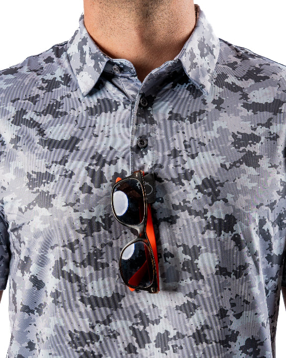 Men’s Arctic Ops golf polo by Pins & Aces featuring an all-over gray, silver, and black camouflage print with short sleeves, collared neckline, and athletic performance fit.
