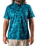 Men’s Cabana Nights golf polo by Pins & Aces featuring a blue and teal tropical leaf print, short sleeves, and athletic performance fit.
