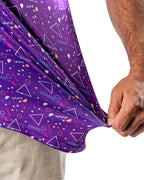 Men’s Eighties Arcade golf polo by Pins & Aces featuring a purple retro geometric print with pink and teal accents, short sleeves, and an athletic performance fit.