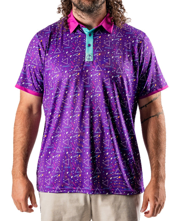 Men’s Eighties Arcade golf polo by Pins & Aces featuring a purple retro geometric print with pink and teal accents, short sleeves, and an athletic performance fit.