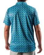 Men’s Fish & Drips golf polo by Pins & Aces featuring a bright aqua blue all-over fish print with colorful fishing-inspired details, short sleeves, and an athletic performance fit.