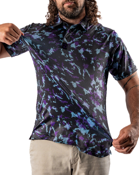Men’s Moon Burn golf polo by Pins & Aces featuring an abstract purple, blue, and black cosmic-inspired pattern with short sleeves and an athletic performance fit.