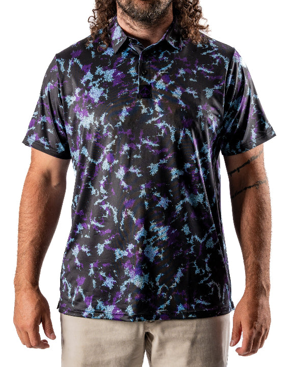Men’s Moon Burn golf polo by Pins & Aces featuring an abstract purple, blue, and black cosmic-inspired pattern with short sleeves and an athletic performance fit.