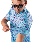 Men’s Purple Majesty golf polo by Pins & Aces featuring an aqua blue base with an all-over purple illustrated mountain print, short sleeves, and athletic performance fit.