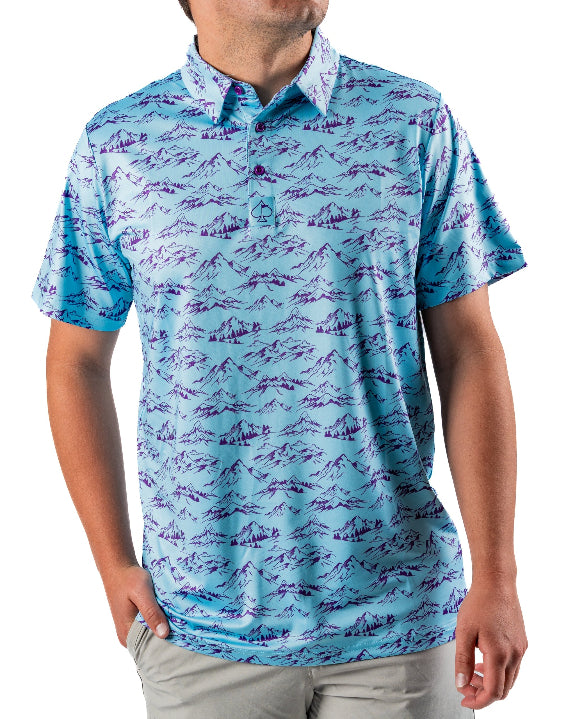 Men’s Purple Majesty golf polo by Pins & Aces featuring an aqua blue base with an all-over purple illustrated mountain print, short sleeves, and athletic performance fit.
