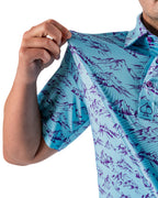 Men’s Purple Majesty golf polo by Pins & Aces featuring an aqua blue base with an all-over purple illustrated mountain print, short sleeves, and athletic performance fit.
