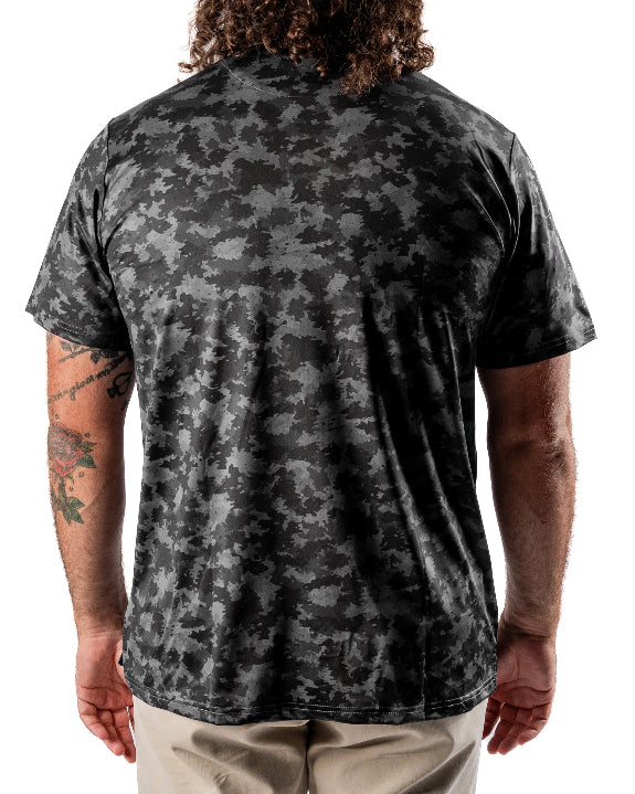 Men’s Shadow Ops black camo golf polo by Pins & Aces featuring a tonal black and charcoal camouflage pattern, short sleeves, collared neckline, and athletic fit.