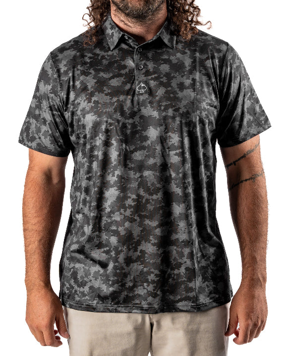 Men’s Shadow Ops black camo golf polo by Pins & Aces featuring a tonal black and charcoal camouflage pattern, short sleeves, collared neckline, and athletic fit.