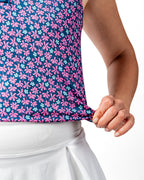 Pins & Aces Women’s Full Bloom performance golf polo featuring a floral-inspired design, women’s athletic fit, fast-wicking fabric and SPF 45+ sun protection.