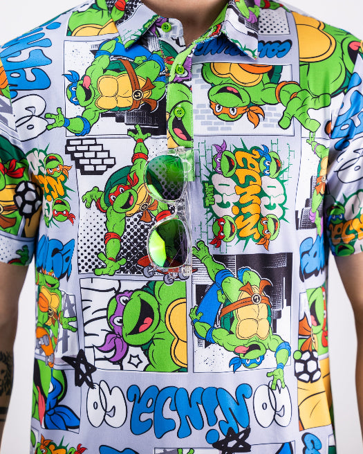 Men’s TMNT Comic Strip golf polo by Pins & Aces featuring colorful Teenage Mutant Ninja Turtles comic artwork in an all-over print.