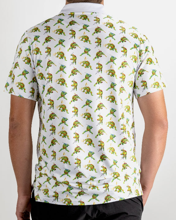 White TMNT Cowabunga Classic 8-Bit golf polo by Pins & Aces featuring an all-over retro pixel-style Teenage Mutant Ninja Turtles character print.