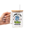 White mug featuring a colorful retro walking book character with flowers and a rainbow, “A Book A Day” lettering, “Read More Cry Less,” and “Keeps the Mental Breakdown Away” text.