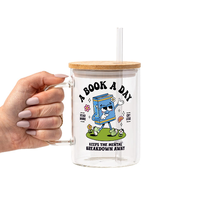 White mug featuring a colorful retro walking book character with flowers and a rainbow, “A Book A Day” lettering, “Read More Cry Less,” and “Keeps the Mental Breakdown Away” text.