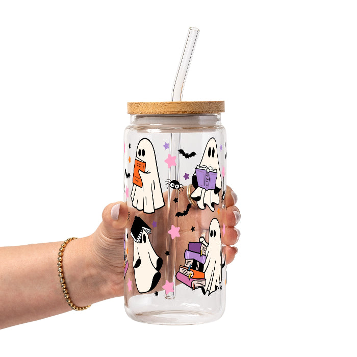 Ghosts and Books drinkware design featuring cute white ghosts reading and carrying colorful books surrounded by black bats and pink, purple and orange stars.
