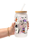 Ghosts and Books drinkware design featuring cute white ghosts reading and carrying colorful books surrounded by black bats and pink, purple and orange stars.