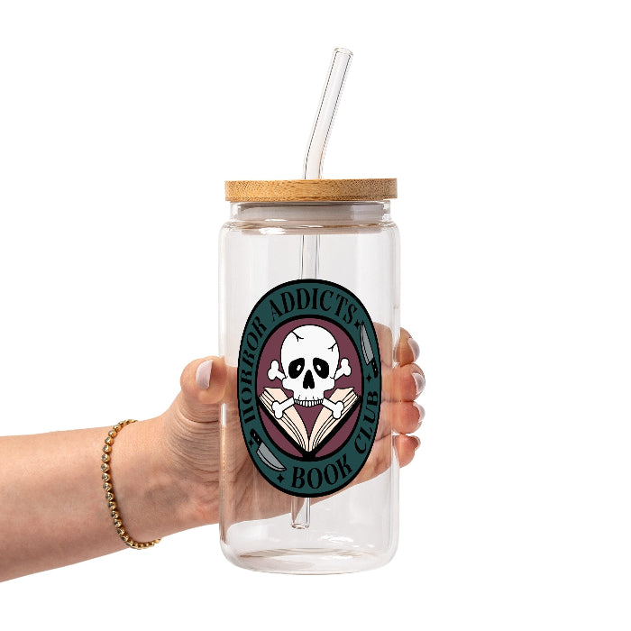 Horror Addicts Book Club design featuring a white skull and crossbones over an open book with knife illustrations, gothic black lettering, and a deep teal and burgundy circular background.