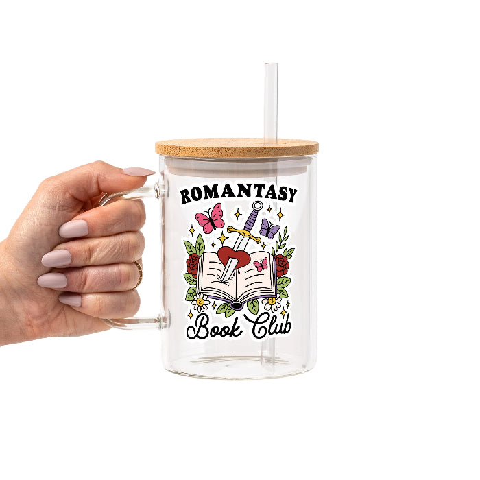 Romantasy Book Club drinkware design featuring an open book pierced by a sword and heart surrounded by red roses, butterflies, flowers, leaves and sparkling fantasy details.