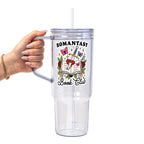 Romantasy Book Club drinkware design featuring an open book pierced by a sword and heart surrounded by red roses, butterflies, flowers, leaves and sparkling fantasy details.