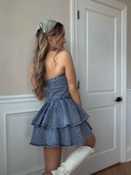 Jolene Strapless Denim Mini Dress featuring a fitted stretch denim bodice, silicone non-slip strapless neckline, ruffled mini skirt, and hidden back zipper for a flattering boutique look.