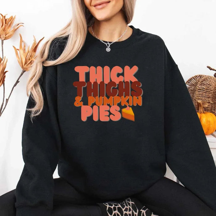 Thick Thighs and Pumpkin Pies fall sweatshirt featuring a funny Thanksgiving-inspired graphic on a cozy unisex crewneck in Black