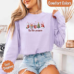 ’Tis The Season Comfort Colors long sleeve Christmas shirt featuring a festive holiday graphic on a soft garment-dyed 100% cotton tee in Orchid