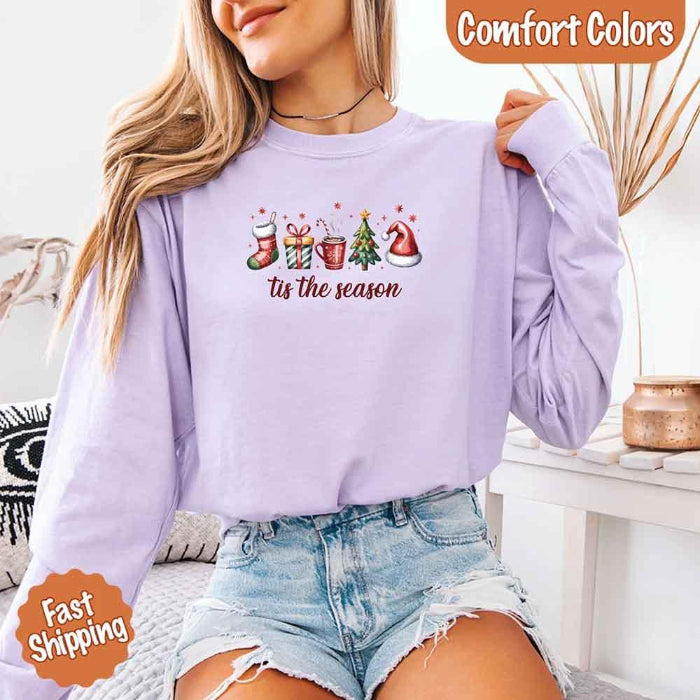 ’Tis The Season Comfort Colors long sleeve Christmas shirt featuring a festive holiday graphic on a soft garment-dyed 100% cotton tee in Orchid