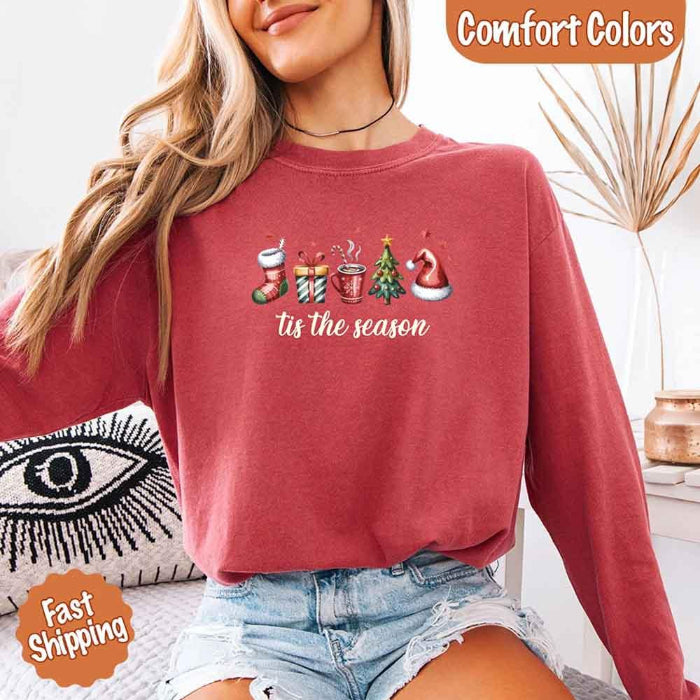 ’Tis The Season Comfort Colors long sleeve Christmas shirt featuring a festive holiday graphic on a soft garment-dyed 100% cotton tee in Crimson