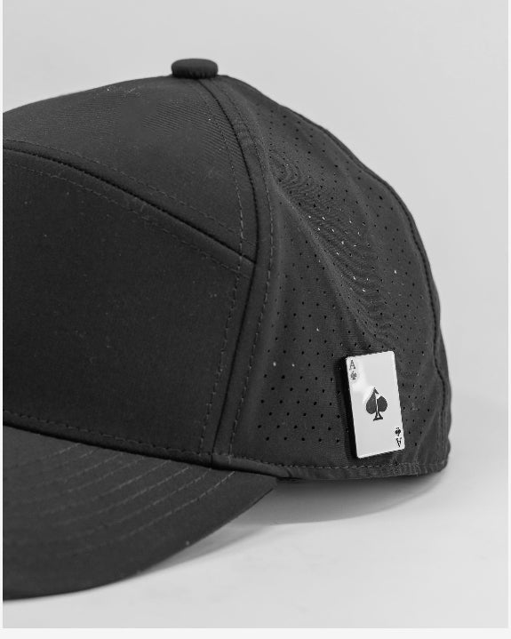 Tradesman Black golf hat by Pins & Aces featuring structured 6-panel construction, adjustable snapback closure, and a built-in magnetic golf ball marker holder.