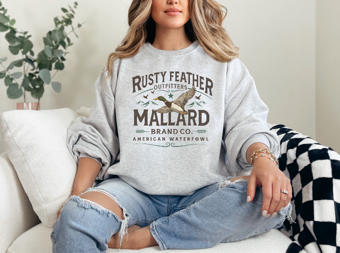 Rusty Feathered Mallard Graphic Tee printed on premium Comfort Colors 100% cotton featuring a detailed vintage-inspired mallard duck design, perfect for outdoor adventures, lake weekends, and casual country style. Crewneck in Grey