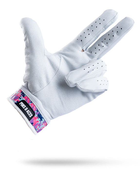 White Pins & Aces Vivid Camo Premium Tour golf glove made from Cabretta leather with perforated fingers and a colorful pink, aqua, purple, and navy camo wrist design.
