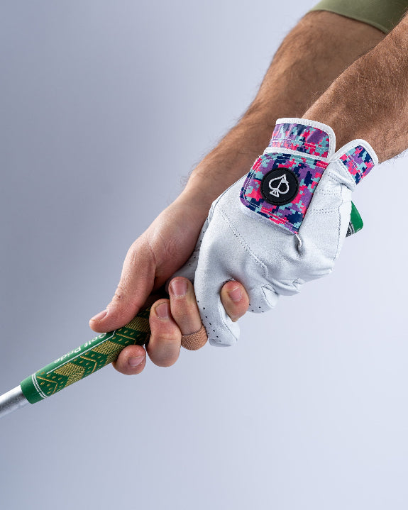 White Pins & Aces Vivid Camo Premium Tour golf glove made from Cabretta leather with perforated fingers and a colorful pink, aqua, purple, and navy camo wrist design.
