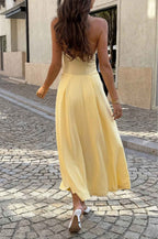Women’s solid halter midi dress featuring a sleeveless neckline, graceful dropped hem, lightweight stretch fabric, and flowing feminine silhouette.