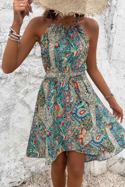 Women’s sleeveless paisley print dress featuring a flattering halter neckline, lightweight fabric, relaxed silhouette, and feminine bohemian-inspired design.