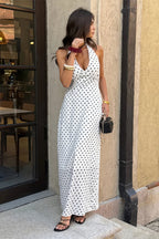 Women’s polka dot halter maxi dress featuring a sleeveless neckline, fitted bodycon silhouette, timeless polka dot print, and elegant long-length design in White.