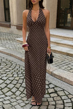 Women’s polka dot halter maxi dress featuring a sleeveless neckline, fitted bodycon silhouette, timeless polka dot print, and elegant long-length design in Brown.