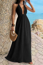 Women’s solid halter maxi dress featuring an elegant neckline, hidden back zipper, flowing A-line skirt, and sophisticated full-length silhouette in black.
