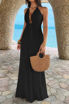 Women’s solid halter maxi dress featuring an elegant neckline, hidden back zipper, flowing A-line skirt, and sophisticated full-length silhouette in black.