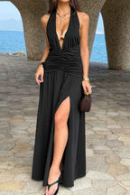 Women’s halter deep V-neck maxi dress featuring flattering ruched detailing, a dramatic high side slit, and an elegant figure-enhancing silhouette.