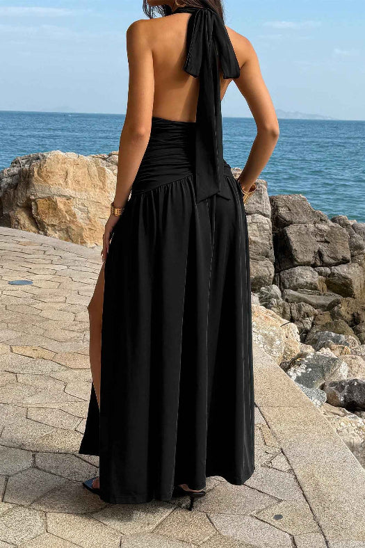 Women’s halter deep V-neck maxi dress featuring flattering ruched detailing, a dramatic high side slit, and an elegant figure-enhancing silhouette.