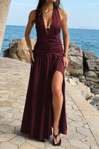 Women’s halter deep V-neck maxi dress featuring flattering ruched detailing, a dramatic high side slit, and an elegant figure-enhancing silhouette.