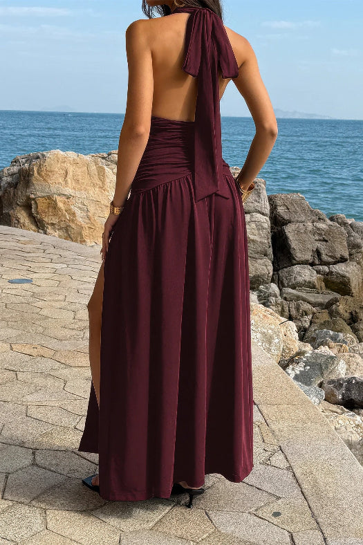 Women’s halter deep V-neck maxi dress featuring flattering ruched detailing, a dramatic high side slit, and an elegant figure-enhancing silhouette.
