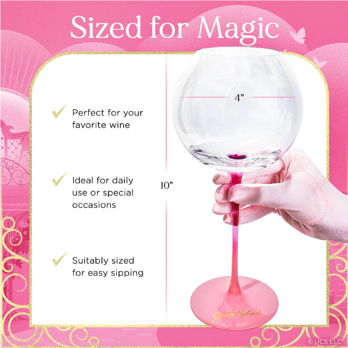 Wine glass with pink stem and base, held by a hand, on a pink background with text about its size and use.