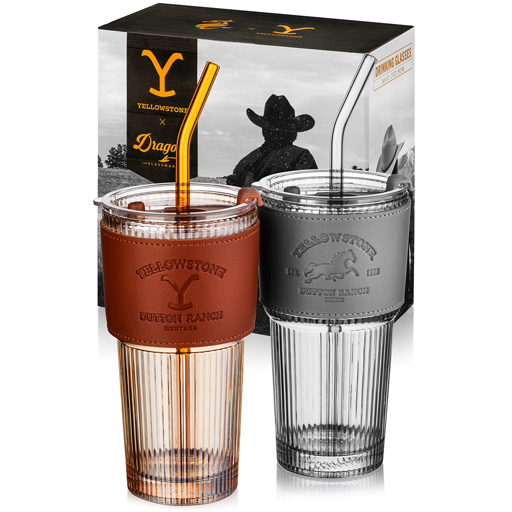 Set of two officially licensed Yellowstone 20-ounce glass drinking tumblers featuring Western-inspired designs with reusable lids and straws.