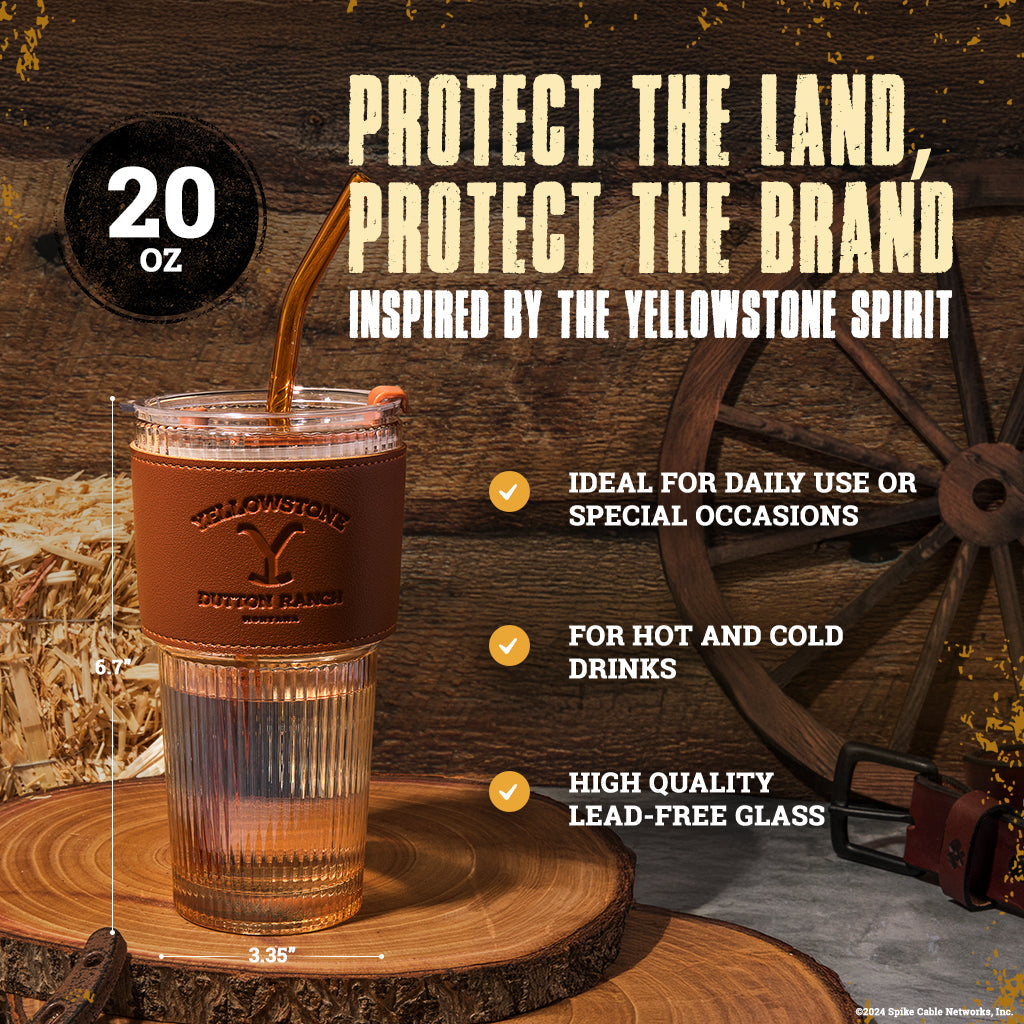 Set of two officially licensed Yellowstone 20-ounce glass drinking tumblers featuring Western-inspired designs with reusable lids and straws.