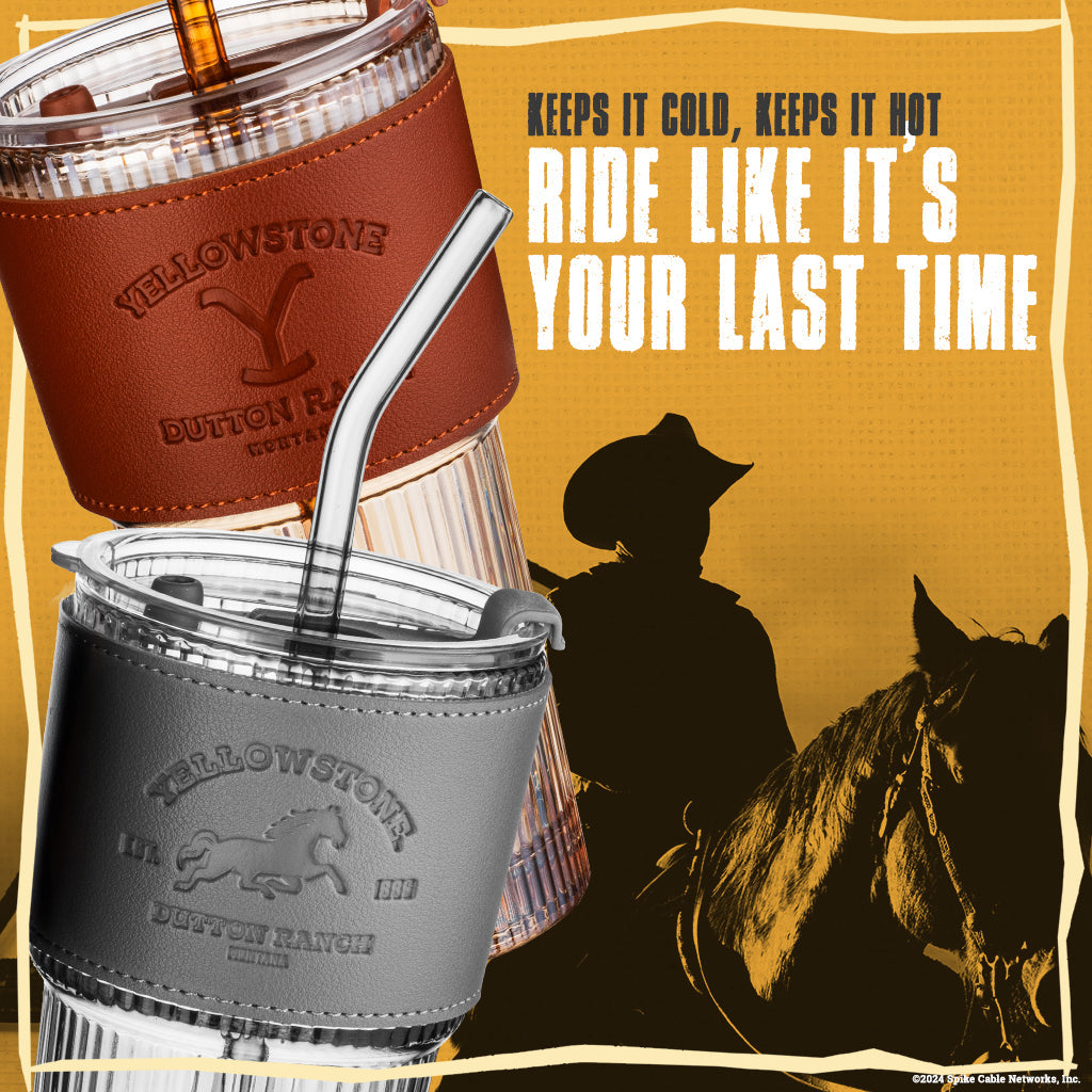 Set of two officially licensed Yellowstone 20-ounce glass drinking tumblers featuring Western-inspired designs with reusable lids and straws.