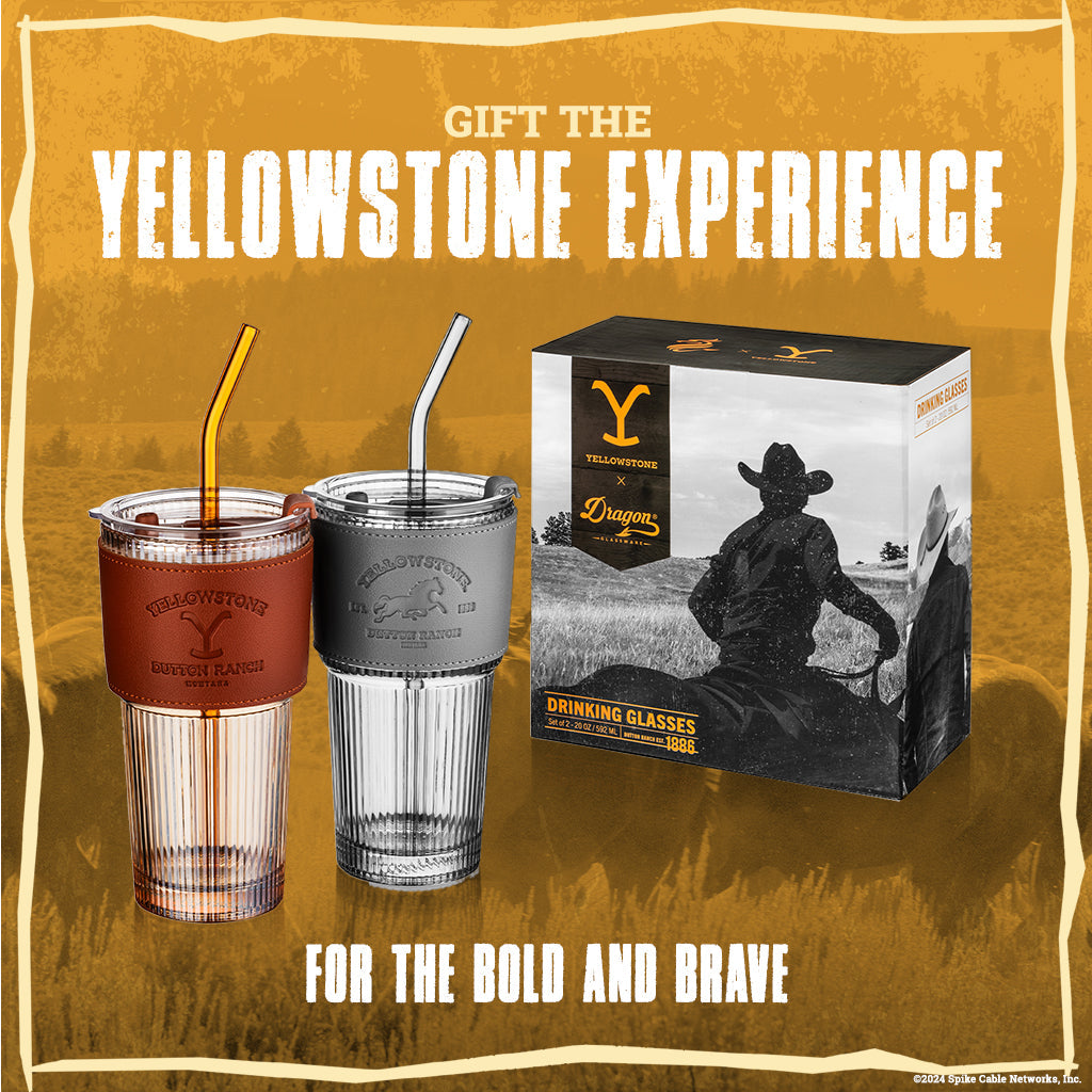 Set of two officially licensed Yellowstone 20-ounce glass drinking tumblers featuring Western-inspired designs with reusable lids and straws.