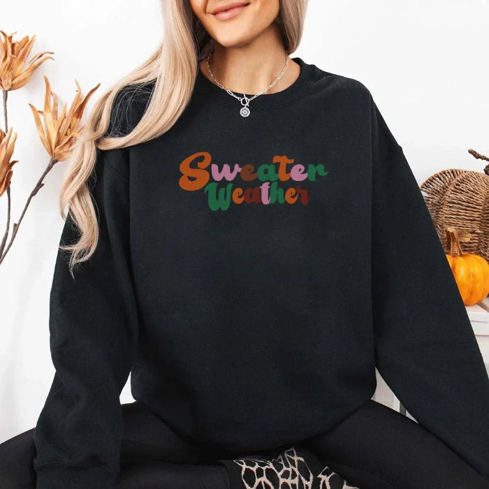 Sweater Weather Fall Vibes unisex crewneck sweatshirt featuring a cozy autumn-inspired graphic design for fall in Black.